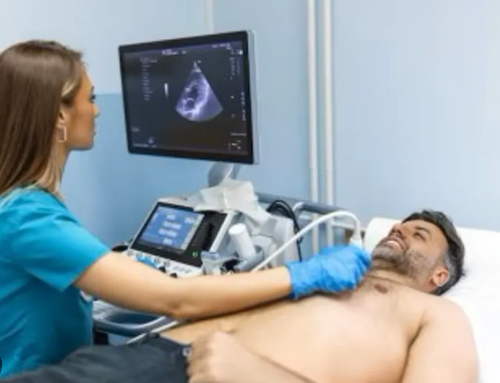 Ultrasound transducer being used on a patient chest to perform 2D echocardiography heart imaging